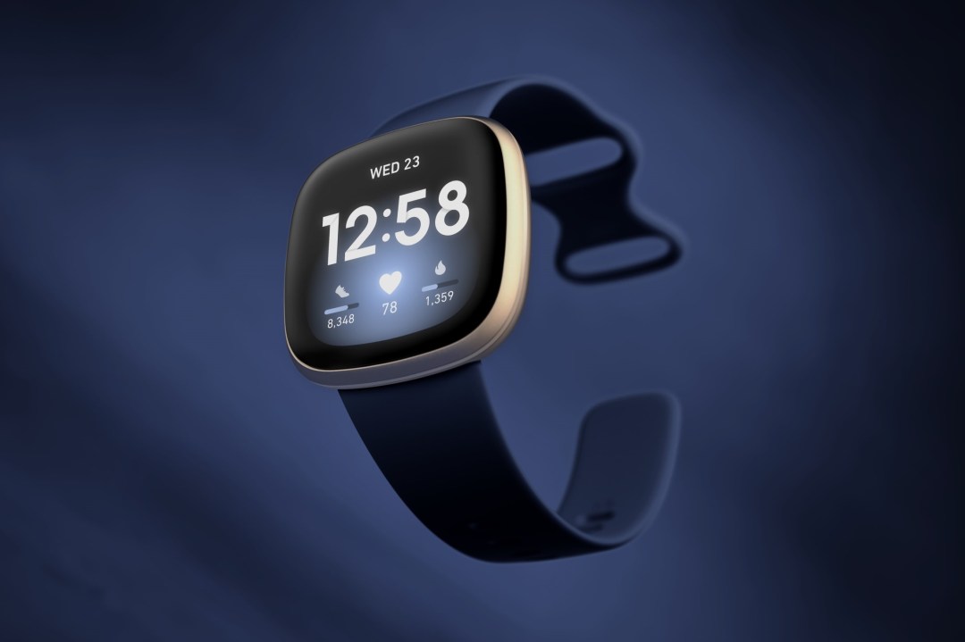 A Fitbit smartwatch against a blue background