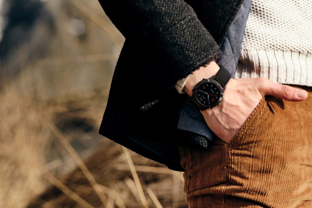 The Garmin Fenix 6 Pro on a man's wrist in the countryside