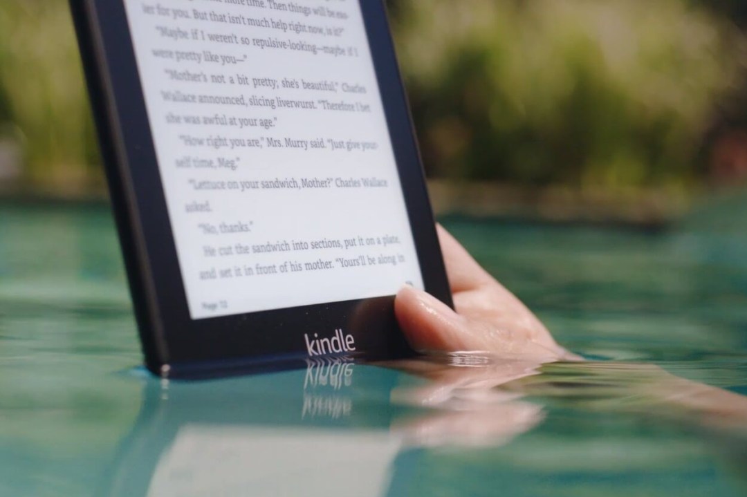 A waterproof Kindle Paperwhite being read in a swimming pool