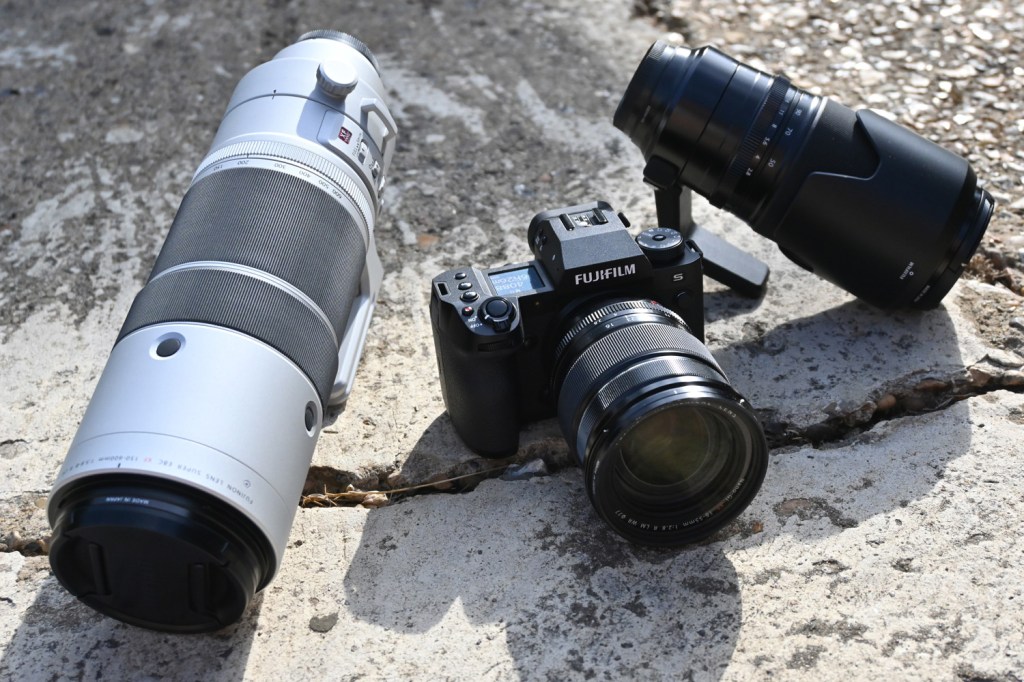 Fuji X-H2S digital system camera between two Fuji lenses