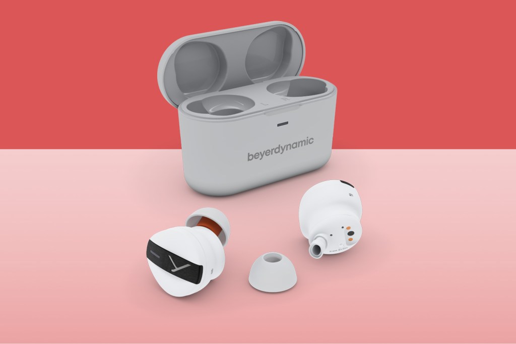 Grey beyerdynamic free BYRD earphones on red background
