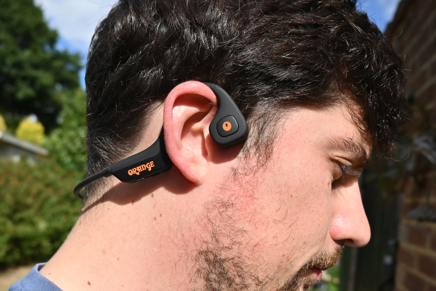 Orange O Bones headphones review wearing close-up