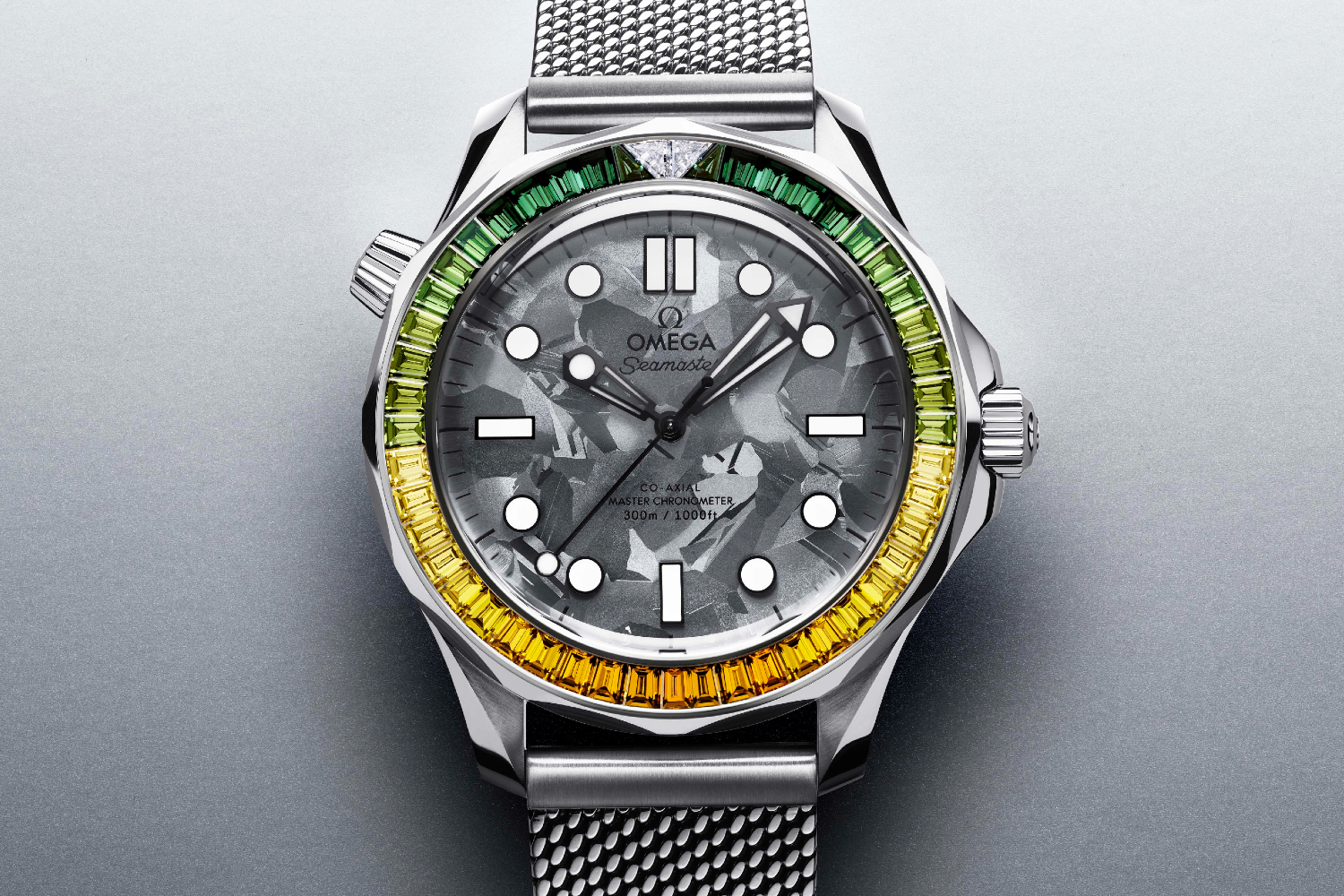 A front-on shot of the gold alloy Omega Seamaster Diver 300M James Bond with green and yellow diamonds on the bezel
