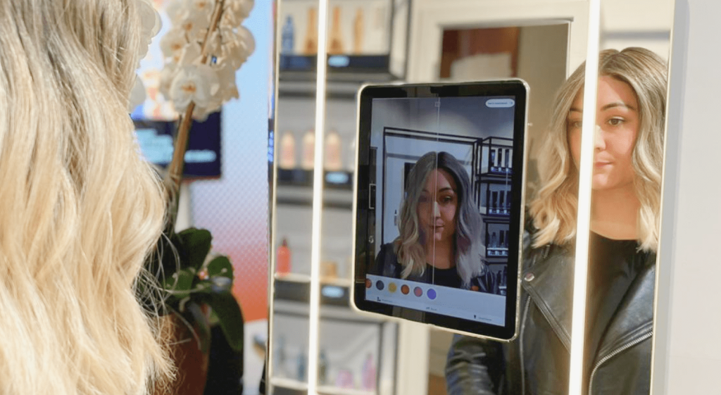 Blonde girl using AR iPad app to test out hair colour