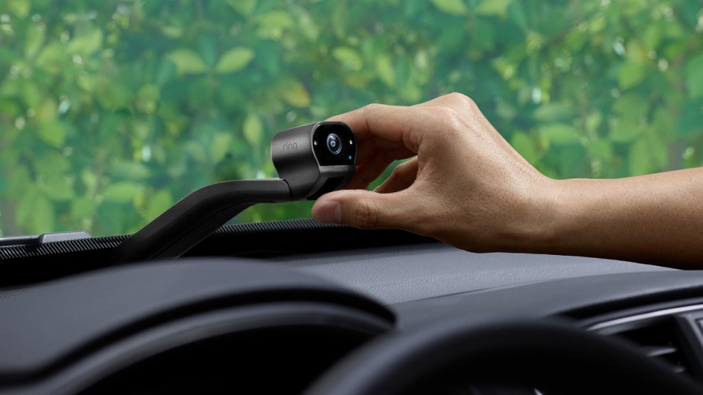 Hand placing new Ring Car Cam in a vehicle