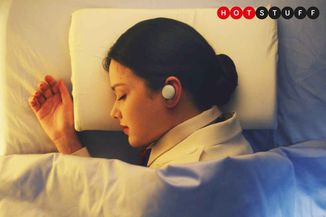 Lady wearing LG Breeze earbuds while laying in bed
